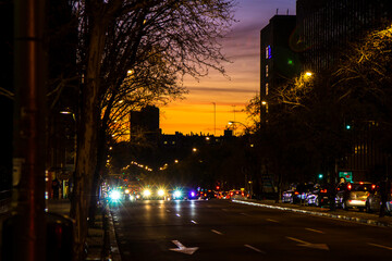 Naklejka premium Madrid, Spain; March 7, 2019. Madrid avenue as it is getting dark with cars waiting at the red light.