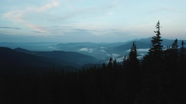 fog enveloped the mountains evening mountains clouds under the mountains forest