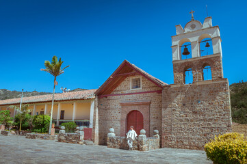 Facade of the church of Sora, Boyacá, Colombia on a beautiful sunny day. Man wearing the typical...