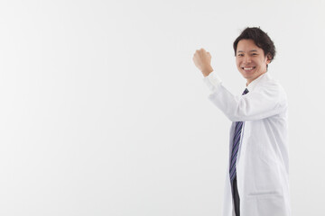 A young Asian doctor standing with energy