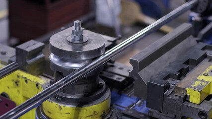 Industrial bender equipment machine for metal pipe bending in the factory. Automatic metalworking machine for electronic turning metal pipe and cold bending at industrial hall at manufacturing plant