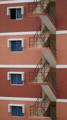 Emergency exit and modern white steel staircase for fire escape outside on modern industrial...