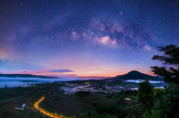 Milky Way galaxies on mountain vantage points in nature, distant photographs with grainy or noisy images, and soft focus.
