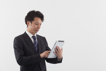 A young Asian businessman using a tablet