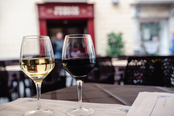 White and red wine glasses. Outdoor restaurant in old town street of Cadiz, Andalusia, Spain.