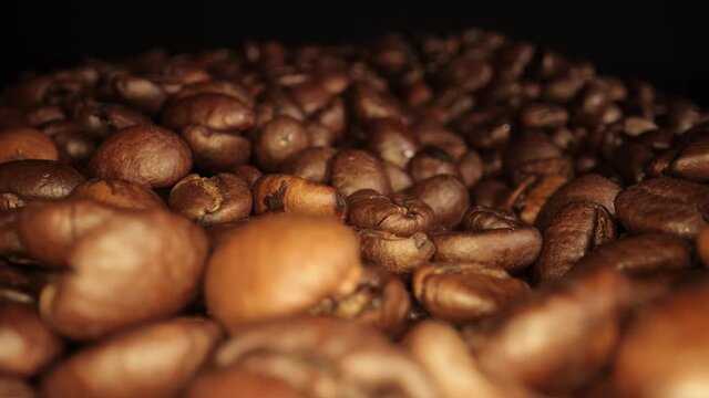 Freshly roasted Coffee Beans - sliding macro shot