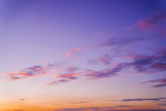 This serene image shows a colorful orange and purple sunset sky.