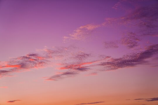 This photograph features a vibrant sunset cloudscape.