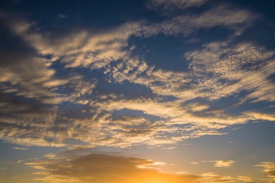 This image showcases a warm sunset sky with glowing clouds.