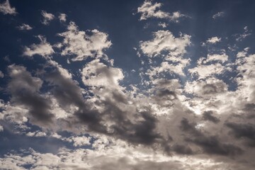 This photograph showcases idyllic white clouds in a calm blue sky.