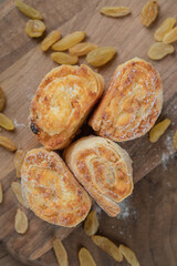 Roll cookies with raisines and stuffings on a wooden board
