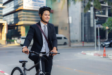 Asian businessman pushing his bicycle from home in the morning preparing to ride his bicycle to...