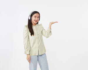 Joyful beautiful young Asian girl in headphones