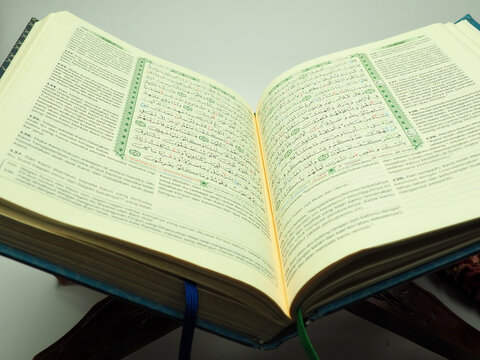 Picture of holy Quran on a wooden table, shoot on a white isolated background