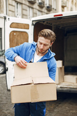 Man by the truck. Guy in a delivery uniform.