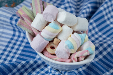 Mixed shape marshmallows in a white saucer or platter