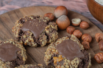 Chocolate nuts cookies on a wooden board