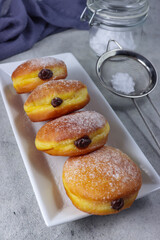 Donat bomboloni labu. Pumpkin bomboloni doughnuts with chocolate filling.