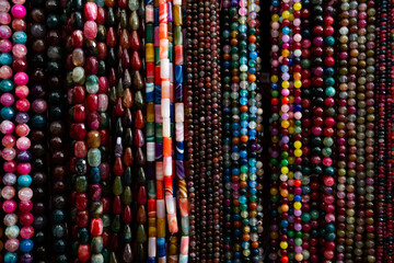 Beads from various gemstones on the showcase of a jewelry store