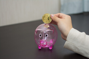 A young woman saves a bitcoin for her future