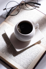 cup of coffee with book and glasses