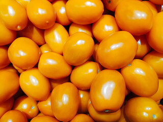 Bright shiny red tomatoes, close-up. Vegetable background, texture