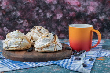 Fried meringue cookie with black raisines and white chocolate on the top served