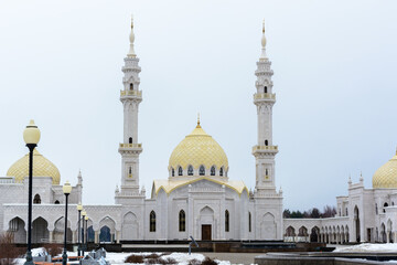 Fototapeta na wymiar Bulgarian settlement. White Muslim mosque of the Bulgarians on a cloudy spring day in Bolgar.
