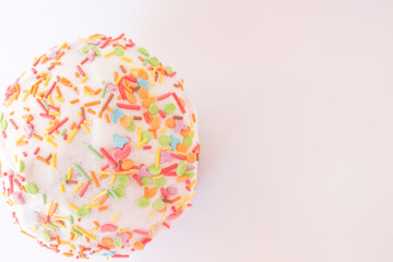 Easter holiday card with cakes and pies for happy saint easter day. White cream on an airy muffin with bright sprinkles of different colors. Happy easter concept. Copy space for your text