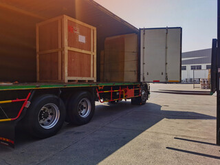Worker driving forklift loading shipment carton boxes goods on wooden pallet at loading dock from container truck to warehouse cargo storage in freight logistics, transportation industrial, delivery