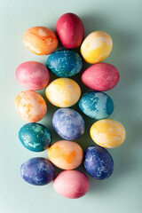 Easter eggs on blue background, top view