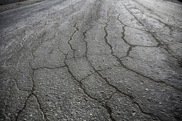 asphalt in cracks texture / abstract background cracks on asphalt road