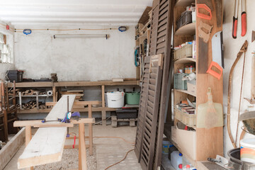 Obraz na płótnie Canvas Various carpenter's tools and supplies in a garage.