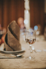 people eating in a restaurant.wine glass close up on table background