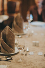people eating in a restaurant.wine glass close up on table background