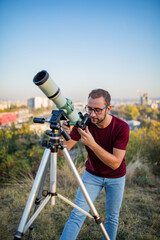 Amateur astronomer looking at the sky with a telescope.