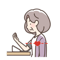 血圧をはかるおばあさん　上腕式測定機