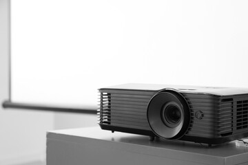 Video projector on table in conference hall