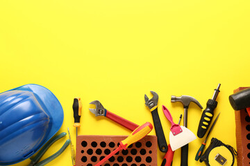 Set of construction tools on color background