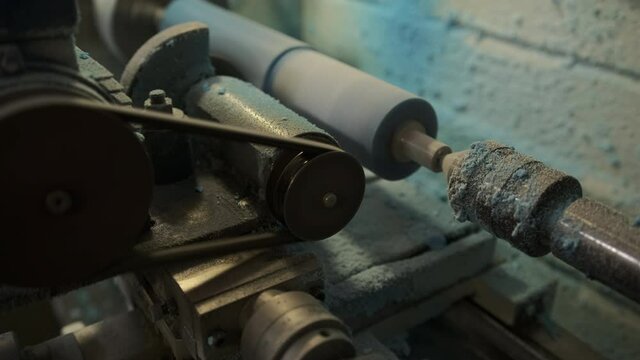 Processing of a polyurethane shaft on a milling equipment. The blue polyurethane roller is milled. Milling work for the production of the required size of parts 
