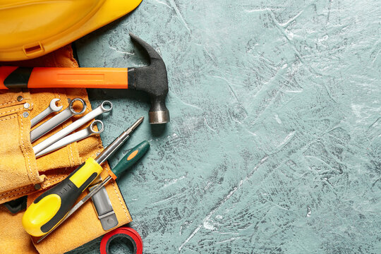 Set of construction tools on color background
