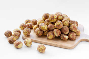 Peeled raw chestnuts on the cutting board. Isolated on white background. 
