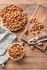 Composition with tasty almonds on wooden background