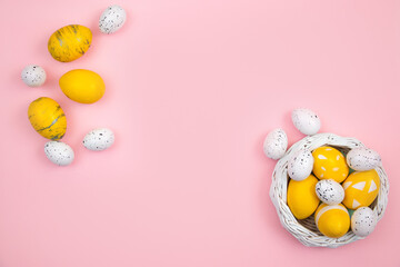 Happy easter concept. Eggs are yellow on a pink pastel background. Flat lay, top view, copy space.