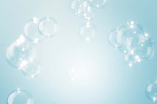 Beautiful shiny transparent soap bubbles float background with copy space.