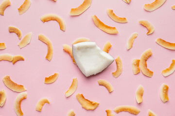 Tasty coconut chips on color background