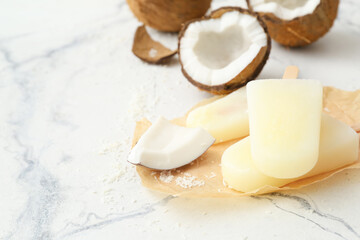 Tasty coconut ice cream on light background