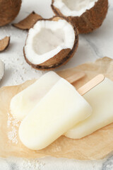 Tasty coconut ice cream on light background
