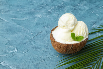 Coconut with tasty ice cream on color background
