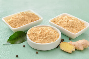 Composition with ginger powder on color background, closeup